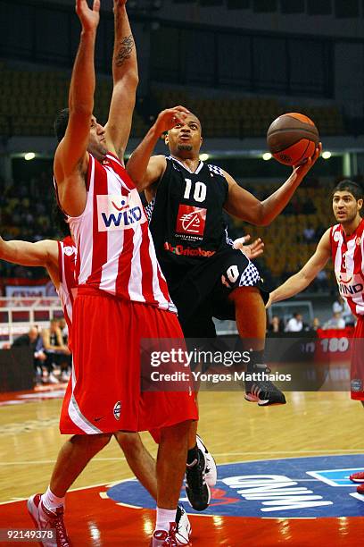Aldo Curti, #10 of Entente Orleanaise competes with Ioannis Bourousis, #9 of Olympiacos Piraeus during the Euroleague Basketball Regular Season Game...