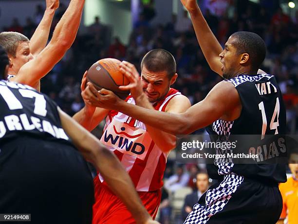 Linas Kleiza, #11 of Olympiacos Piraeus pulls down the rebound over Ludovic Vaty, #14 of Entente Orleanaise during the Euroleague Basketball Regular...