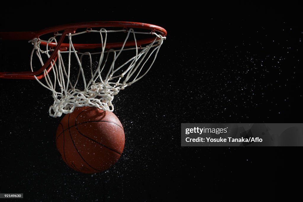Run Through Hoops Basketball Going Through Hoop Against Black Background High-Res Stock ...