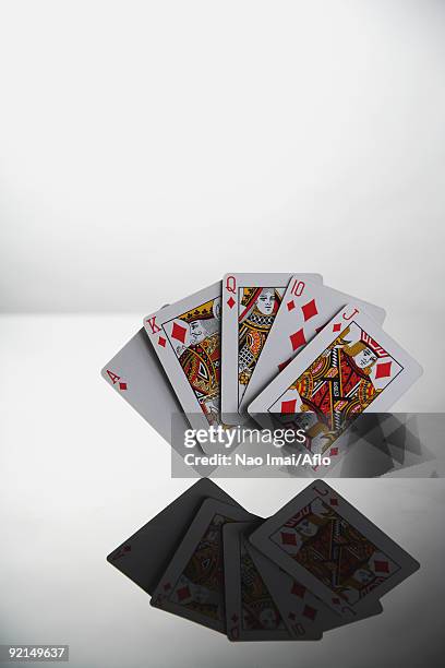 poker,hand showing reflection of royal flush in diamond - ace of diamonds stock pictures, royalty-free photos & images