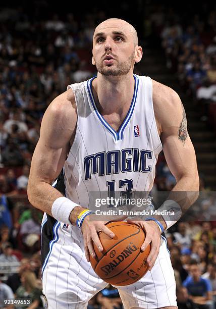 Marcin Gortat of the Orlando Magic shoots a free throw during the preseason game against the Houston Rockets on October 9, 2009 at Amway Arena in...