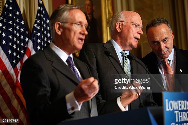 Sen. Patrick Leahy and Sen. Charles Schumer confer as Senate Majority Leader Sen. Harry Reid speaks during a news conference on Capitol Hill in...