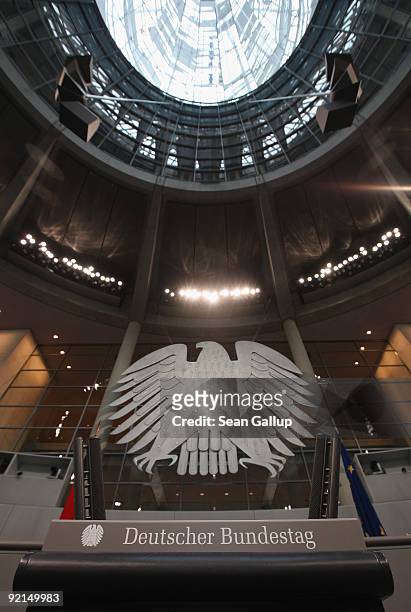 The inscription "Deutscher Bundestag," or "German Bundestag," stands on the speaker's podium under the eagle that symbolizes the federal German state...