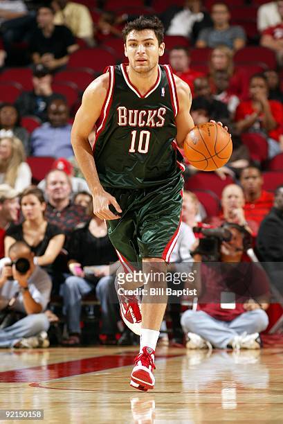 Carlos Delfino of the Milwaukee Bucks moves the ball up court against the Houston Rockets during a preseason game at Toyota Center on October 12,...