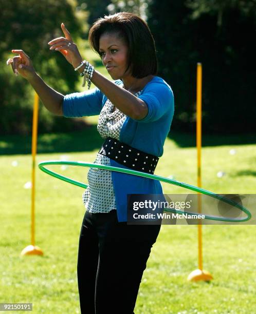 First lady Michelle Obama hula hoops on the South Lawn of the White House during an event promoting exercise and healthy eating for children October...
