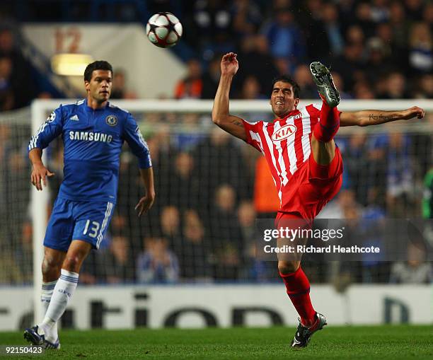 Raul Garcia of Atletico Madrid clears the ball as Michael Ballack of Chelsea looks on during the UEFA Champions League Group D match between Chelsea...