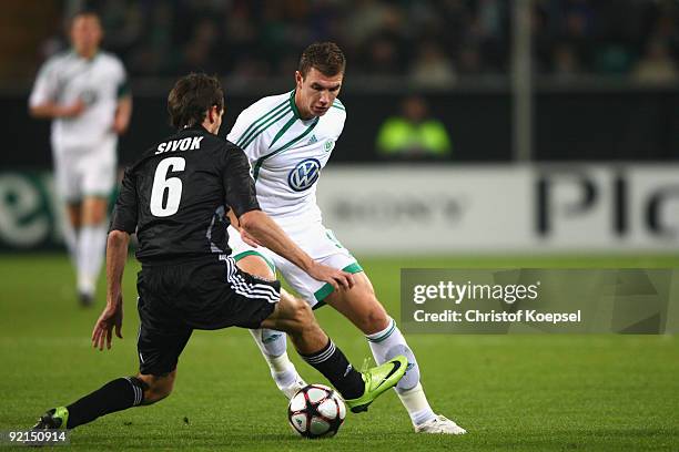 Tomas Sivok of Besiktas Istanbul tackles Edin Dzeko of Wolfsburg during the UEFA Champions League Group B first leg match between VfL Wolfsburg and...