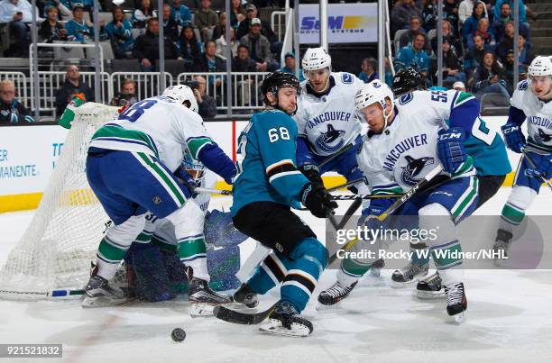 Alex Biega of the Vancouver Canucks defends the net against Melker Karlsson of the San Jose Sharks at SAP Center on February 15, 2018 in San Jose,...