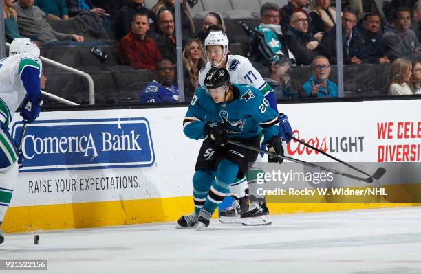 Marcus Sorensen of the San Jose Sharks skates after the puck against Nikolay Goldobin of the Vancouver Canucks at SAP Center on February 15, 2018 in...