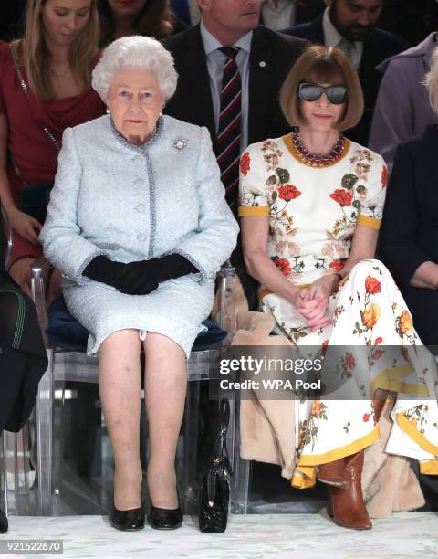 Queen Elizabeth II sits next to Anna Wintour as they view Richard Quinn's runway show before presenting him with the inaugural Queen Elizabeth II...