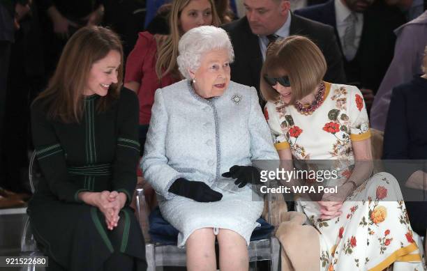 Queen Elizabeth II sits next to Anna Wintour and Caroline Rush, chief executive of the British Fashion Council as they view Richard Quinn's runway...
