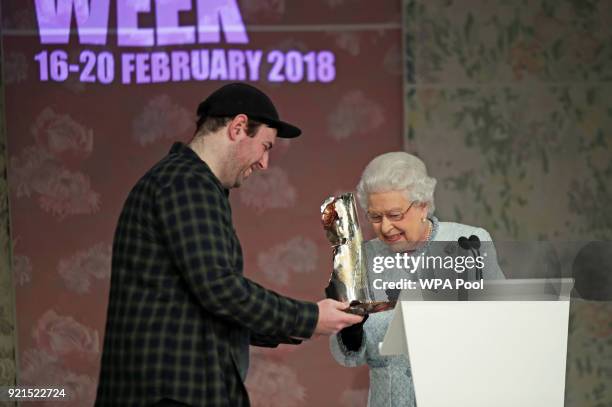 Queen Elizabeth II presents Richard Quinn with the inaugural Queen Elizabeth II Award for British Design, as she visits London Fashion Week's BFC...