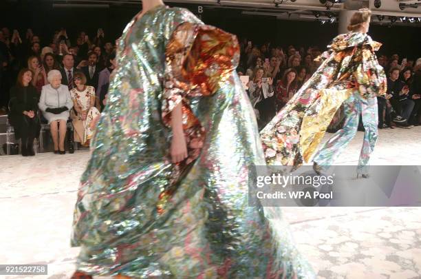 Queen Elizabeth II sits next to Anna Wintour and Caroline Rush, chief executive of the British Fashion Council as they view Richard Quinn's runway...