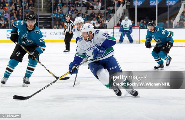 Alex Biega of the Vancouver Canucks skates with the puck against the San Jose Sharks at SAP Center on February 15, 2018 in San Jose, California.