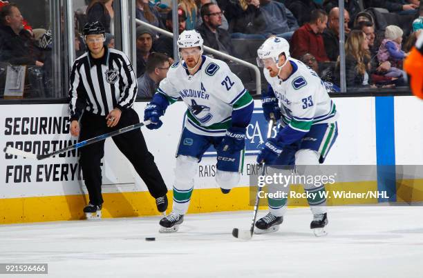 Daniel Sedin and Henrik Sedin of the Vancouver Canucks skate against the San Jose Sharks at SAP Center on February 15, 2018 in San Jose, California.