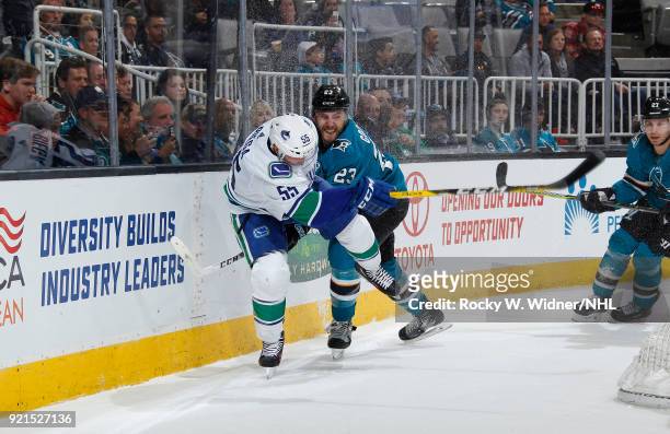Alex Biega of the Vancouver Canucks skates against Barclay Goodrow of the San Jose Sharks at SAP Center on February 15, 2018 in San Jose, California.