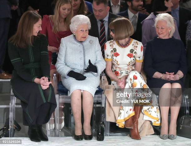 Britain's Queen Elizabeth II, accompanied by Chief Executive of the British Fashion Council , Caroline Rush , British-American journalist and editor,...