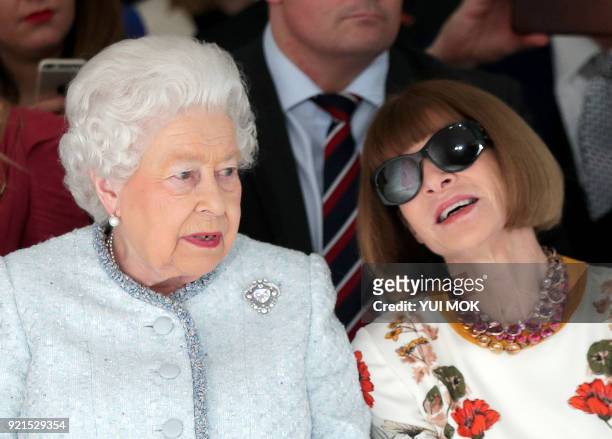 Britain's Queen Elizabeth II, accompanied by British-American journalist and editor, Anna Wintour , views British designer Richard Quinn's runway...