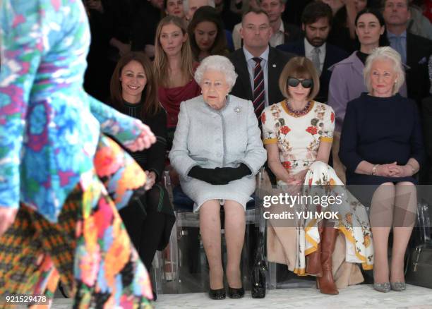 Britain's Queen Elizabeth II, accompanied by Chief Executive of the British Fashion Council , Caroline Rush , British-American journalist and editor,...