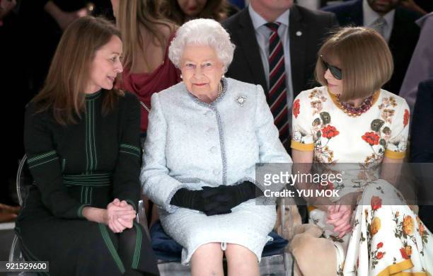 Britain's Queen Elizabeth II, accompanied by Chief Executive of the British Fashion Council , Caroline Rush and British-American journalist and...