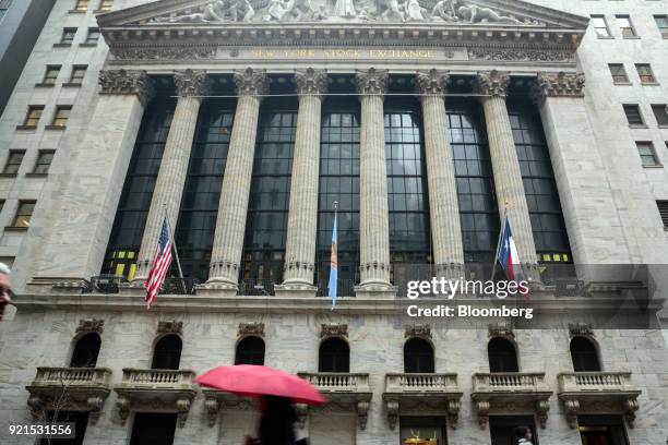 Pedestrians pass in front of the New York Stock Exchange in New York, U.S., on Tuesday, Feb. 20, 2018. Treasuries fell, with investors driving the...