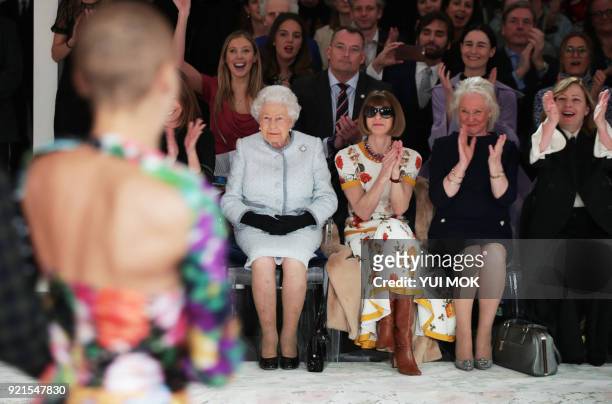 Britain's Queen Elizabeth II, accompanied by British-American journalist and editor, Anna Wintour and royal dressmaker Angela Kelly, , views British...