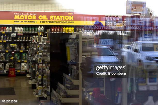 Vehicles are reflected in the window of an Advance Auto Parts Inc. Store in Phoenix, Arizona, U.S., on Monday, Feb. 19, 2018. Advance Auto Parts is...