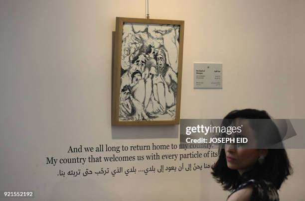People visit the exhibition "Haneen, a Collective Work of Lebanese and Syrian artists on the impact of war on childhood", in Beirut on February 20,...