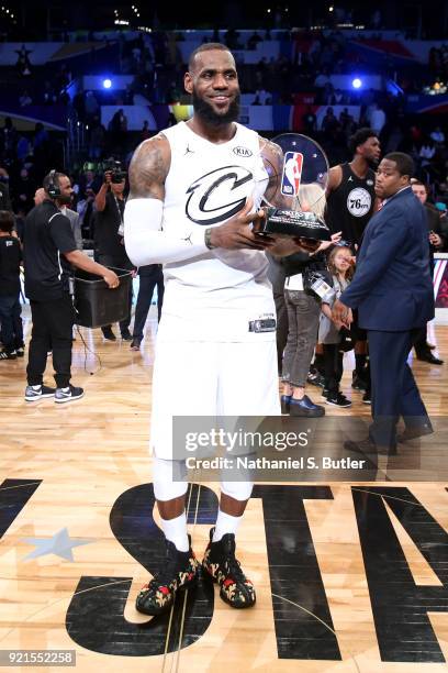 LeBron James of Team LeBron is presented the MVP trophy for the NBA All-Star Game as a part of 2018 NBA All-Star Weekend at STAPLES Center on...