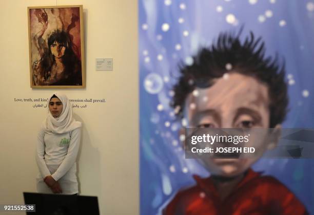 People visit the exhibition "Haneen, a Collective Work of Lebanese and Syrian artists on the impact of war on childhood", in Beirut on February 20,...