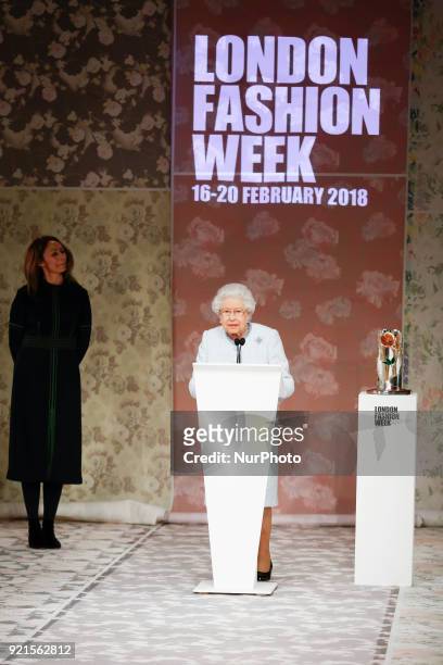 The Queen Elizabeth II is presenting the award which carries her name to the winning designer Richard Quinn at the London Fashion Week on the...