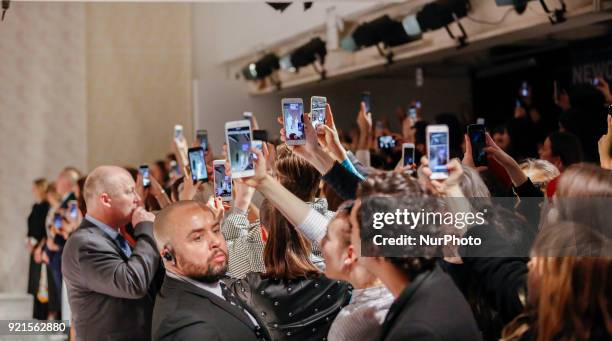 The Queen Elizabeth II is presenting the award which carries her name to the winning designer Richard Quinn at the London Fashion Week on the...