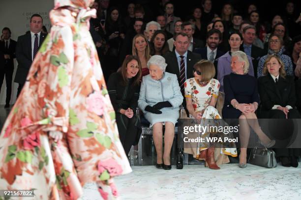 Queen Elizabeth II sits with Caroline Rush , chief executive of the British Fashion Council , Anna Wintour and royal dressmaker Angela Kelly ) as...