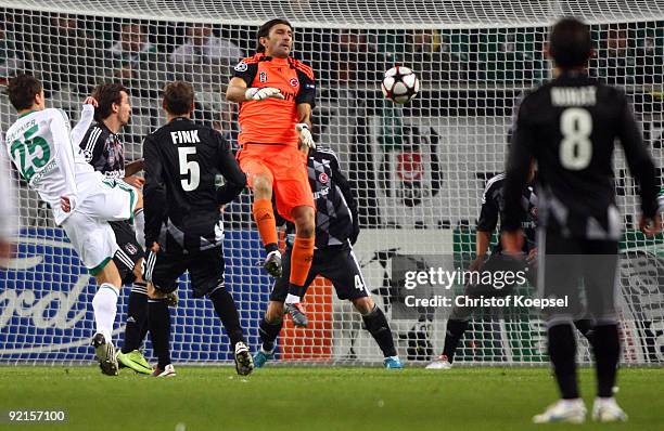 Christian Gentner of Wolfsburg shoots the ball and Ruestue Recber of Besiktas Istanbul saves the ball during the UEFA Champions League Group B first...