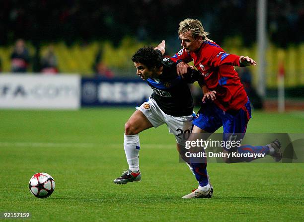 Milos Krasic of PFC CSKA Moscow fights for the ball with Fabio of Manchester United FC during the UEFA Champions League group B match between CSKA...