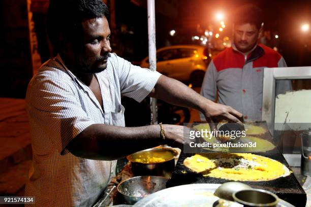 street food being prepared at night outdoor on the road - street food stock pictures, royalty-free photos & images