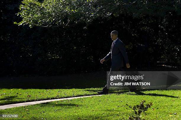 President Barack Obama walks out of the Oval Office to Marine One at the White House in Washington, DC, as he prepares to depart for New Jersey...