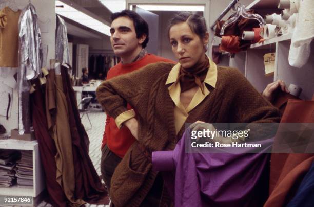 Fashion designers Louis Dell'Olio and Donna Karan stand together in the Anne Klein workroom located in New York city's garment district, 1980.