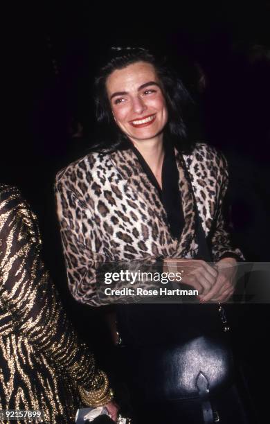 View of American fashion designer Norma Kamali, dressed in a leopard print jacket, smiles as she attends an unspecified fashion event, New York, New...