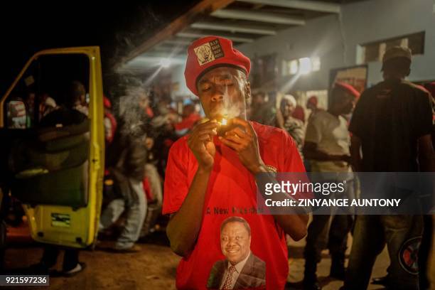 In this photograph taken on February 19 a young supporter of the late opposition Movement for Democratic Change leader Morgan Tsvangirai lights a...
