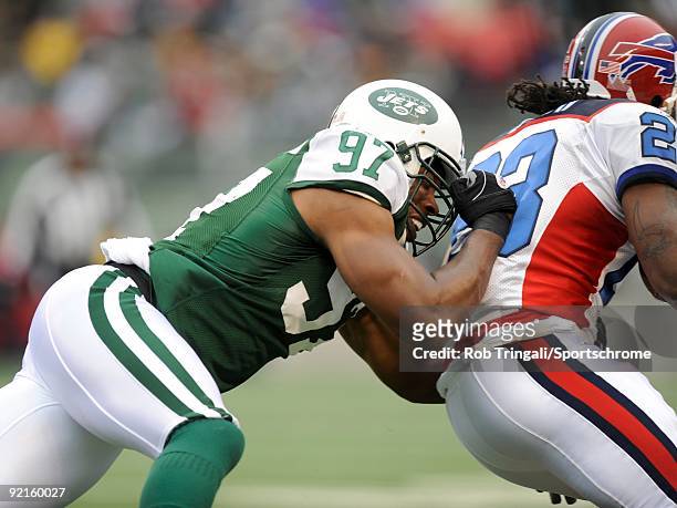 Calvin Pace of the New York Jets tackles Marshawn Lynch of the Buffalo Bills at Giants Stadium on October 18, 2009 in East Rutherford, New Jersey....