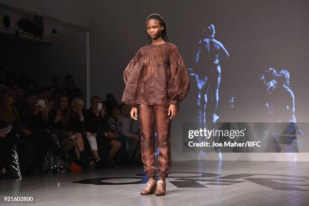 Model walks the runway at the On|Off Presents show during London Fashion Week February 2018 at BFC Show Space on February 20, 2018 in London, England.