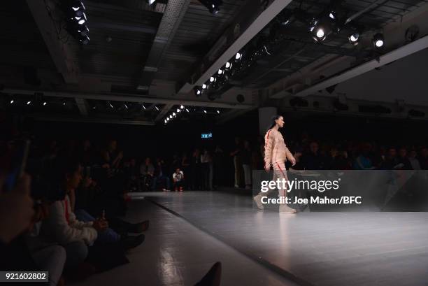 Model walks the runway at the On|Off Presents show during London Fashion Week February 2018 at BFC Show Space on February 20, 2018 in London, England.