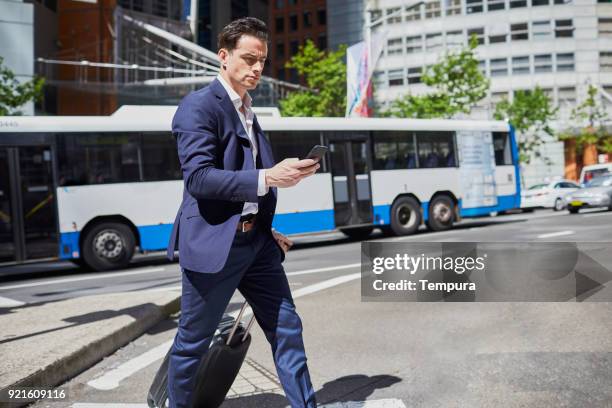 business-mann mit einem smartphone pendeln. - sydney buses stock-fotos und bilder