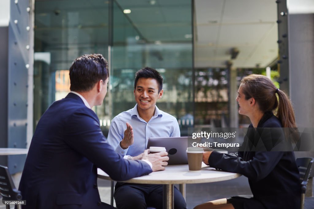 Corporate business meeting outdoors on the move.