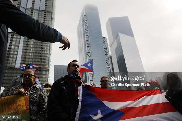 Puerto Rican activists and others participate in a protest outside of New York City's Federal Emergency Management Agency office to call on Congress...