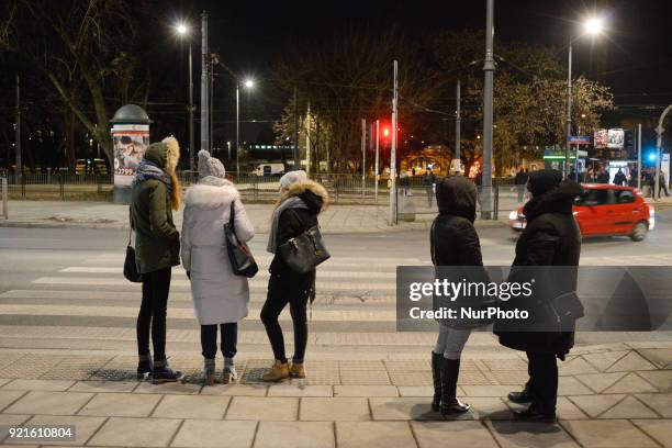 Pedestrians are seen waiting for a traffic light in the Praga district of Warsaw, Poland on February 20, 2018.