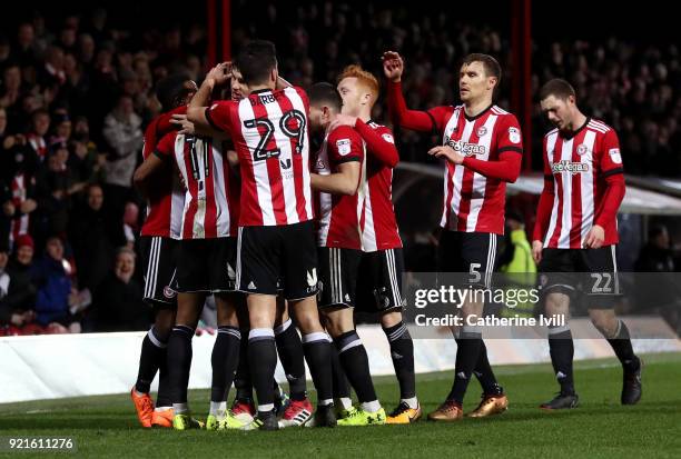 Ollie Watkins of Brentford celebrates with teammates after scoring the first Brentford goal during the Sky Bet Championship match between Brentford...