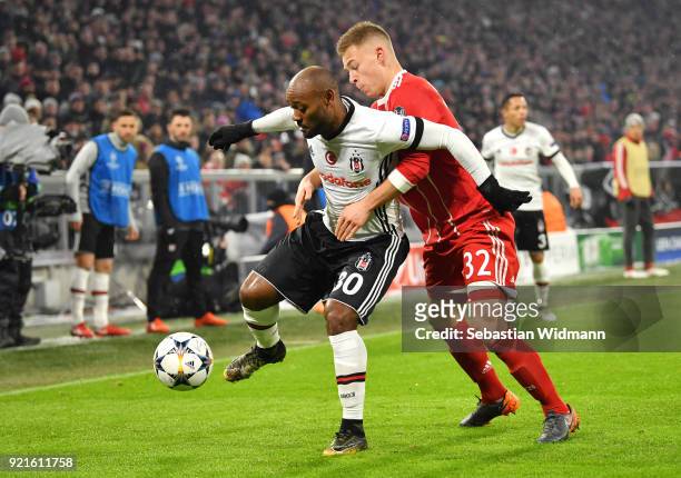 Vagner Love of Besiktas is challenged by Joshua Kimmich of Bayern Muenchen during the UEFA Champions League Round of 16 First Leg match between...