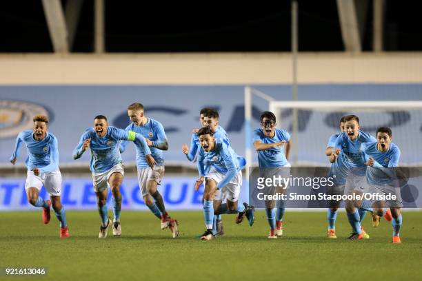 Man City players celebrate victory following a penalty shootout at the end of the UEFA Youth League Round of 16 match between Manchester City and...